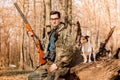 Portrait of a yang hunter with a dog on the forest