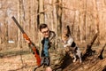 Portrait of a yang hunter with a dog on the forest