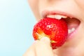 Portrait of yaung woman eating strawberries. Healthy happy smiling woman eating strawberry.