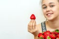 Portrait of yaung woman eating strawberries. Healthy happy smiling woman eating strawberry.