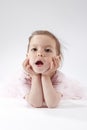 Portrait of Yawning Little Caucasian Blond Child Posing in Pink