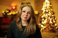 Portrait of a 30 year old beautiful woman in a festive new year interior Royalty Free Stock Photo