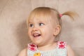 Portrait of a 2-year-old blonde girl with blue eyes with two ponytails looking to the side. Royalty Free Stock Photo