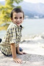 Portrait of 9 year old boy smiling with colorful shirt sitting o Royalty Free Stock Photo