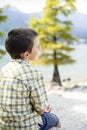 Portrait of 9 year old boy smiling with colorful shirt sitting o Royalty Free Stock Photo