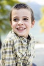 Portrait of 9 year old boy smiling with colorful shirt sitting o Royalty Free Stock Photo