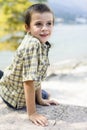 Portrait of 9 year old boy smiling with colorful shirt sitting o Royalty Free Stock Photo