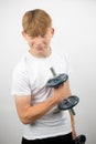 Teenage boy using a dumbbell Royalty Free Stock Photo