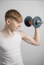 Teenage boy using a dumbbell Royalty Free Stock Photo