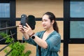 Portrait of a 32 year old Japanese woman, taking a photo with her smartphone Royalty Free Stock Photo