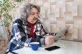 A portrait of a 60-year old man reading news. A newspaper in a pensioners hands Royalty Free Stock Photo