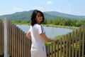 Portrait of 45 year old Russian brunette woman turned back and looking at the camera. windy summer day near lake Royalty Free Stock Photo