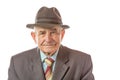 Portrait of 90 year old senior man in retro hat looking at camera isolated on white background