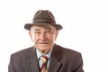 Portrait of 90 year old senior man in retro hat looking at camera isolated on white background Royalty Free Stock Photo