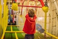Portrait of 6 years old boy wearing helmet and climbing. Child in abstacle course in adventure playground Royalty Free Stock Photo