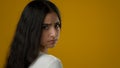 Portrait in yellow studio sad upset stressed Indian ethnic woman suffer with anxiety female anxious face depressed girl