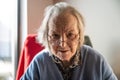 Portrait of an 85 yo white grandmother sitting, Tienen, Belgium