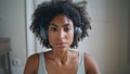 Portrait yoga girl inhaling at home. African headphones woman meditating alone