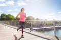 Woman running across a bridge during morning run Royalty Free Stock Photo