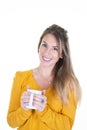 Portrait of young adorable blonde woman enjoying her warm cozy hot drink tea coffee in big blank white mug cup Royalty Free Stock Photo