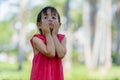 Stressed young multi ethnic girl looking bored and tired at the park outdoors