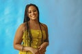 portrait of young adult beautiful african american woman smiling with braid hair posing at studio looking at camera Royalty Free Stock Photo