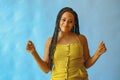 portrait of young adult beautiful african american woman smiling and dancing with braid hair posing at studio Royalty Free Stock Photo