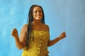portrait of young adult beautiful african american woman smiling and dancing with braid hair posing at studio Royalty Free Stock Photo