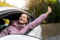 Portrait of young adult beautiful caucasian woman driver enjoy roadtrip adventure traveling by car on mountain nature Royalty Free Stock Photo