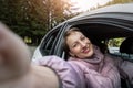 Portrait of young adult beautiful caucasian woman driver enjoy roadtrip adventure traveling by car on mountain nature