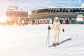 Portrait of young adult beautiful happy caucasian woman smiling near lift station at alpine winter skiing resort. Girl in fashion Royalty Free Stock Photo