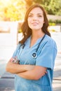 Portrait of Young Adult Female Doctor or Nurse Wearing Scrubs an Royalty Free Stock Photo