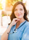 Portrait of Young Adult Female Doctor or Nurse Wearing Scrubs an Royalty Free Stock Photo