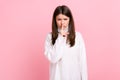 Portrait of young adult female showing shh sign, keeping finger near her lips, keep silent, please. Royalty Free Stock Photo