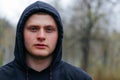 Portrait of a Young Adult Male with a Striking Gaze in Rainy Weather Royalty Free Stock Photo