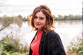 Portrait of young adult red-haired woman outdoors on the river bank Royalty Free Stock Photo