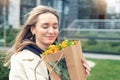 Portrait young adult smiling classy woman model hand holding authentic fresh orange spray roses flower bouquet wrapped in craft Royalty Free Stock Photo