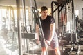 Portrait of young adult sport athlete man training at gym alone, standing and lifting weights in the gym, doing exercises for Royalty Free Stock Photo