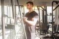 Portrait of young adult sport athlete man training at gym alone, standing and lifting weights in the gym, doing exercises for Royalty Free Stock Photo