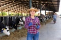 Woman farmer standing with syringe at farm Royalty Free Stock Photo