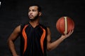 Young African-American basketball player in sportswear isolated over dark background. Royalty Free Stock Photo