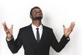 Portrait of a young African American in a business suit. emotions on the face. man throws up his hands and looks to the Royalty Free Stock Photo