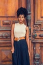 Portrait of Young African American Businesswoman in New York. Young black female teacher with afro hairstyle wearing sleeveless Royalty Free Stock Photo