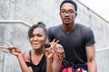 Portrait of young African American couple making funny faces whi