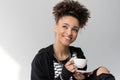 Portrait of young african american girl holding cup of tea isolated Royalty Free Stock Photo