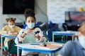 Teenage Girl Sanitizing Hands in School