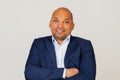 Portrait of young african american guy businessman, happy face, smiling with crossed arms, looking at camera. A positive person. Royalty Free Stock Photo