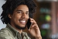 Portrait Of Young African American Guy Talking On Cellphone In Cafe, Closeup Royalty Free Stock Photo