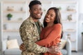 Portrait Of Young African American Male Soldier And Wife Hugging At Home Royalty Free Stock Photo