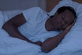 Portrait of young african american man sleeping in bed in the night Royalty Free Stock Photo